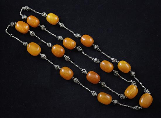 A single strand amber bead and filligree white metal necklace, 37in.